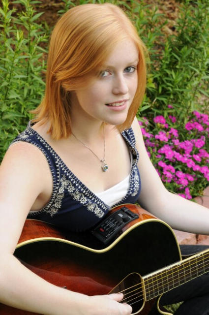 young redhead woman with guitar